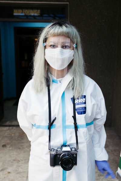 The woman in a white long sleeve shirt wearing a white mask
